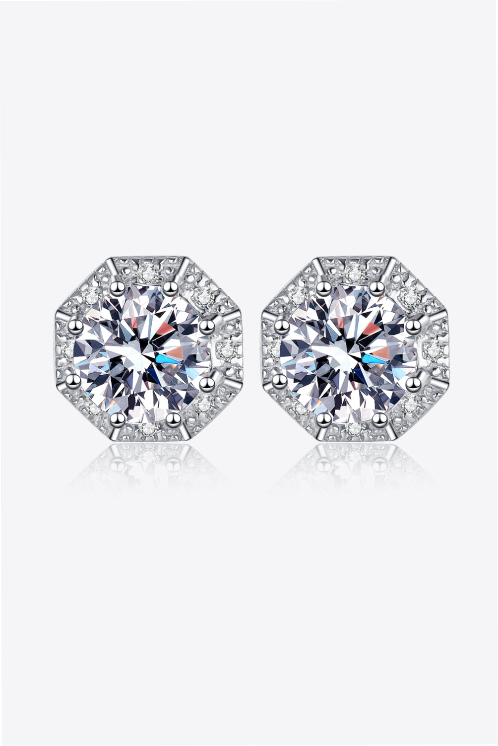 Pair of two-carat round moissanite stud earrings in silver-tone settings