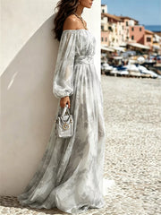Side view of the grey-and-white dress showing gathered cuffs and full-length hem