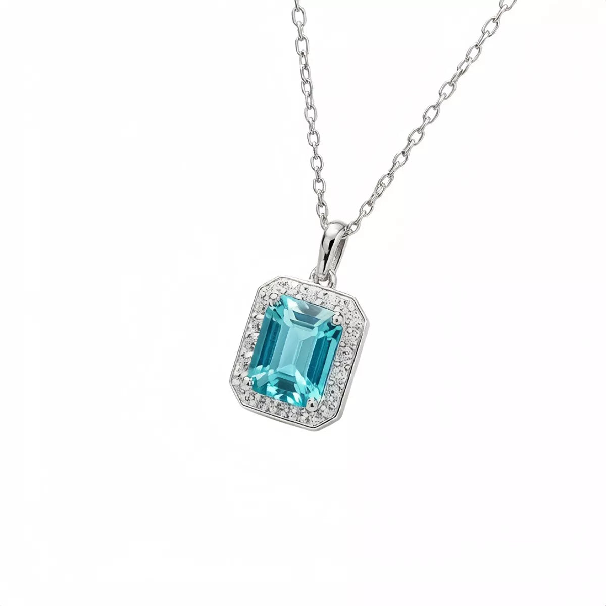 Turquoise-blue rectangular halo pendant necklace on white background
