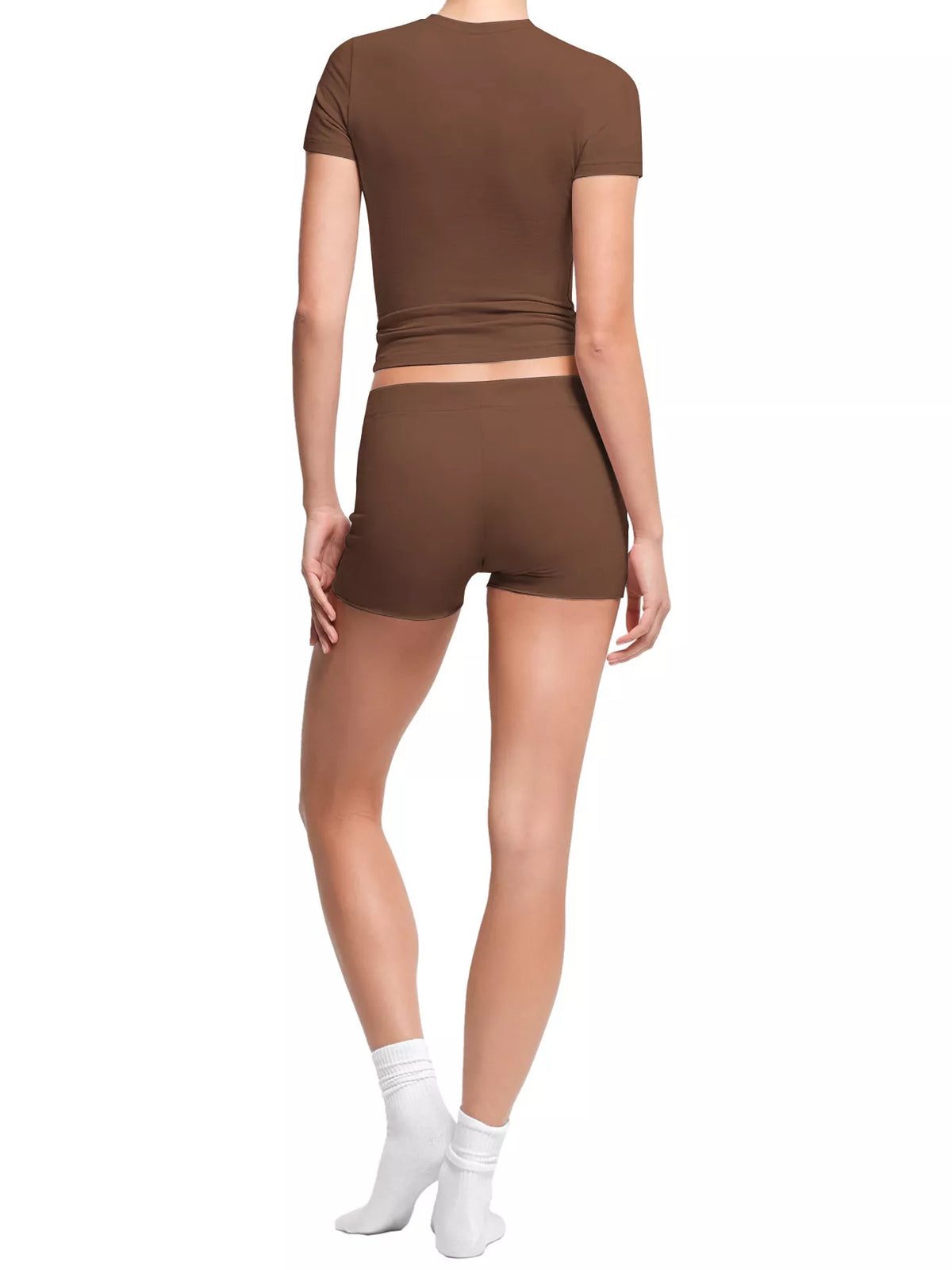 Woman modeling brown ribbed crop top and shorts set, three-quarter pose