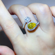 Yellow pear-shaped centre stone with pavé halo and opposing cluster, worn on hand