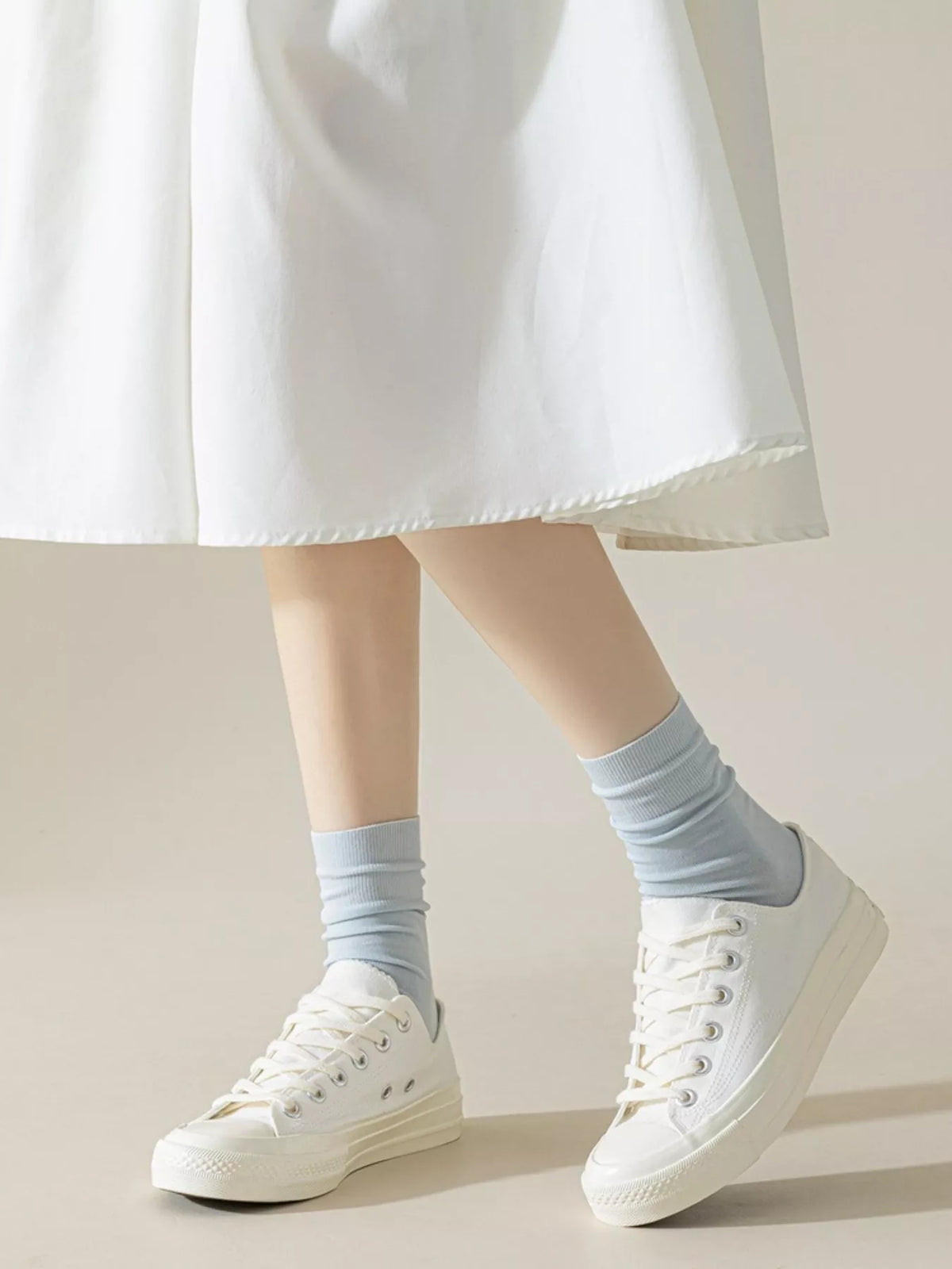 Light blue crew socks styled with white sneakers
