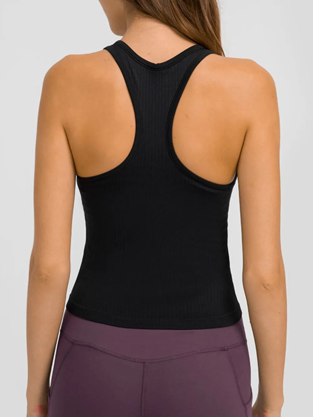 Back view of black racerback tank on model