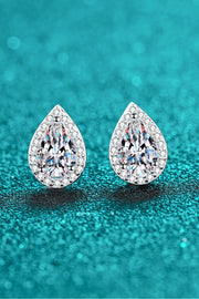 Pair of teardrop stone studs on a teal textured surface