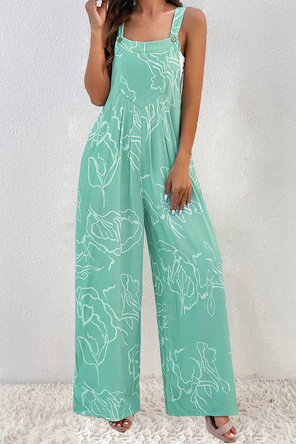 Turquoise printed wide-strap jumpsuit modeled from the front