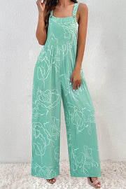 Turquoise printed wide-strap jumpsuit modeled from the front