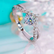 Close-up of the blue rectangular gemstone and silver ring setting held between fingers.