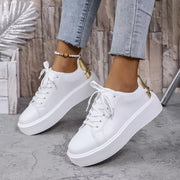Pair of white lace-up platform sneakers shown from the side