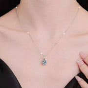 Moissanite pendant necklace worn at the neckline