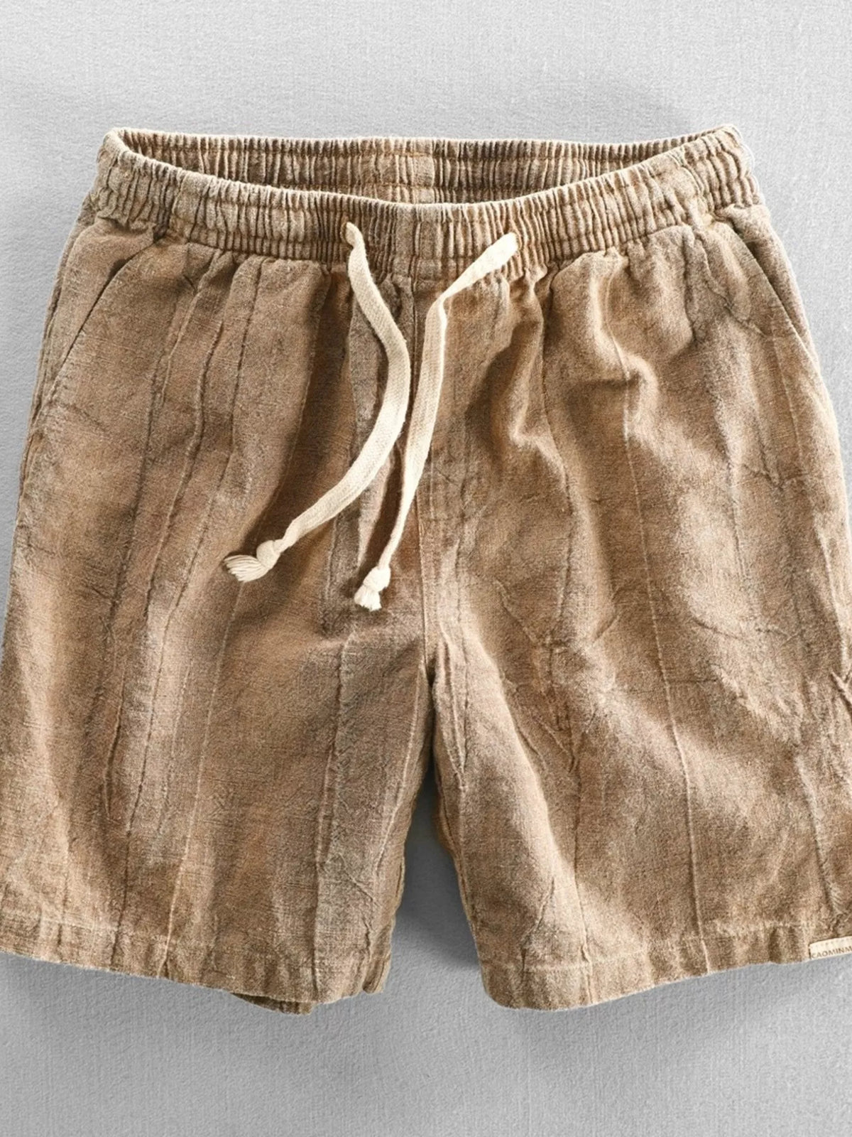 Front view of tan shorts with drawstring waist