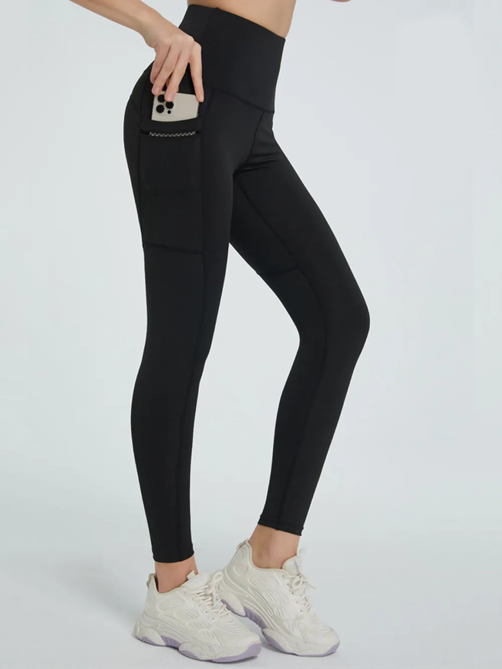 Black high-waisted active leggings with side phone pocket, shown from side