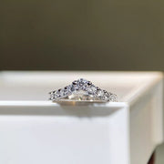 V-shaped ring displayed from the front on a light surface.
