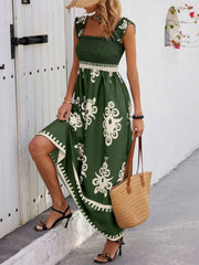 Model wearing a dark green smocked floral maxi dress