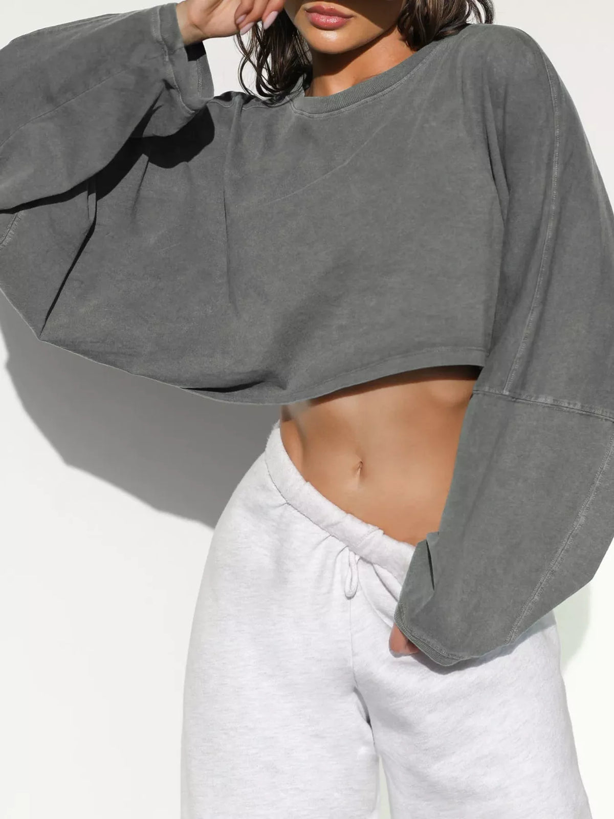 Charcoal cropped sweatshirt worn with light gray drawstring pants