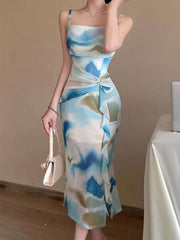 Front three-quarter view of the blue watercolor-print ruched midi dress with shoulder straps.