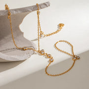 Rhinestone hand chain displayed on a jewelry stand