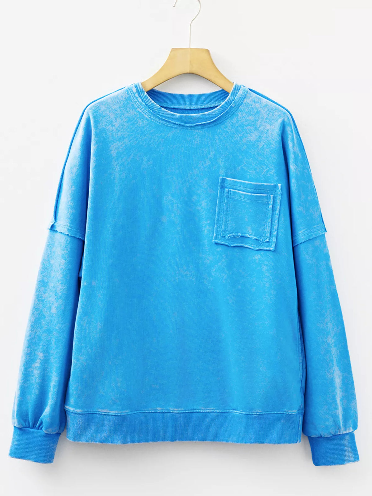 Women's mineral-wash blue raw-seam pocket sweatshirt, front hanging view