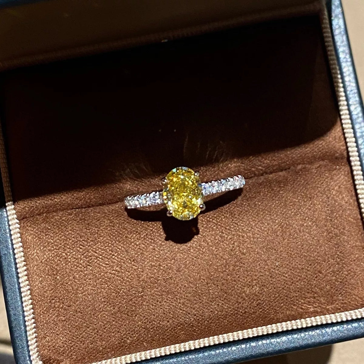 Copper oval zircon ring with polished yellow finish, back view