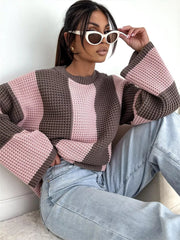 Close front view of pink and brown sweater showing broad vertical blocks and knit texture