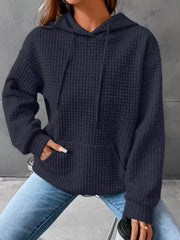 Navy blue textured hooded sweatshirt worn with jeans