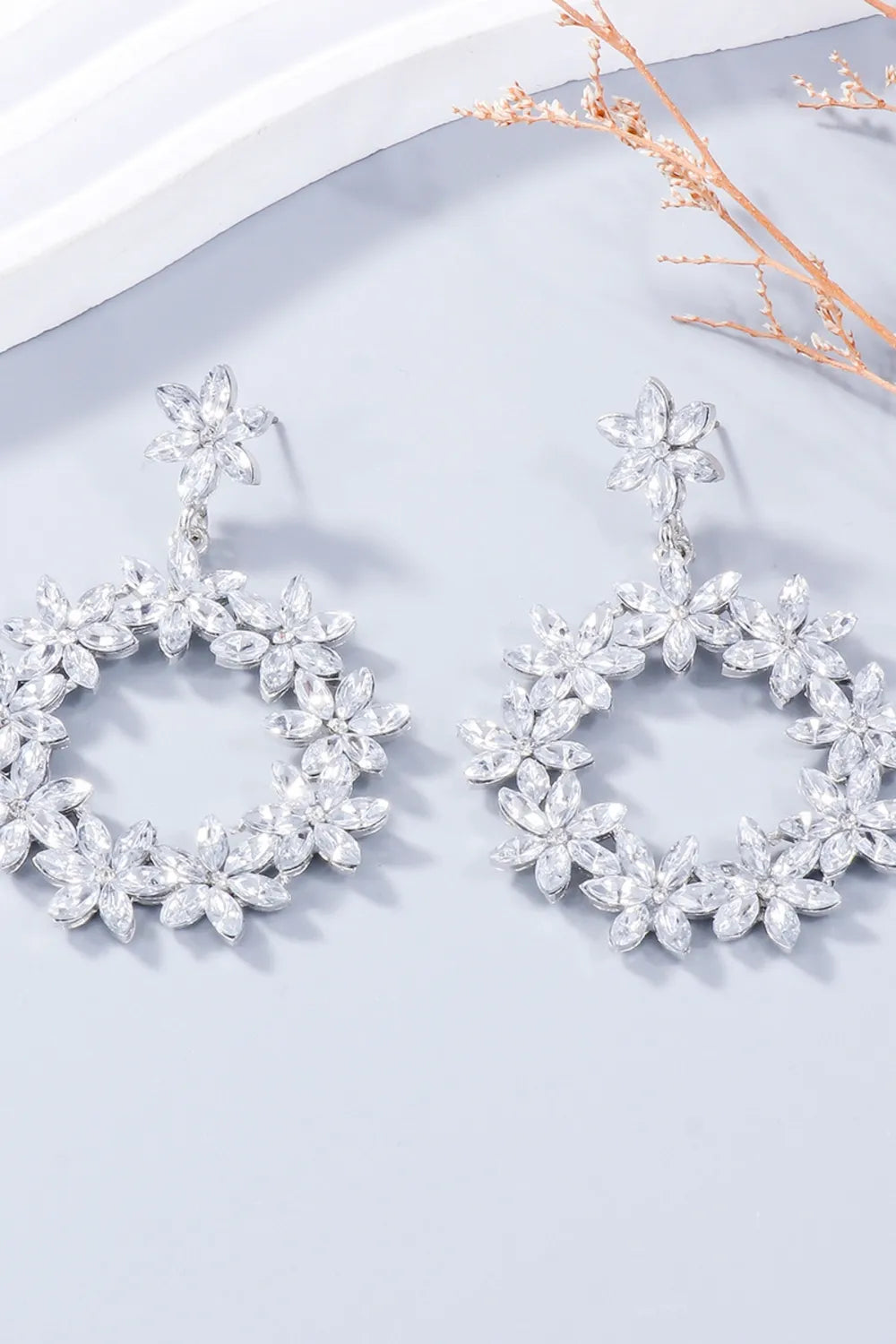 Pair of white flower-shaped rhinestone drop earrings
