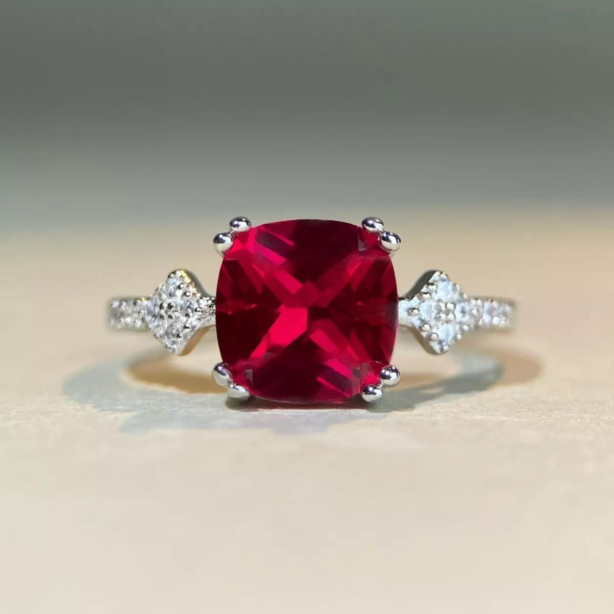 Front view of the red rectangular zircon ring on a light surface.