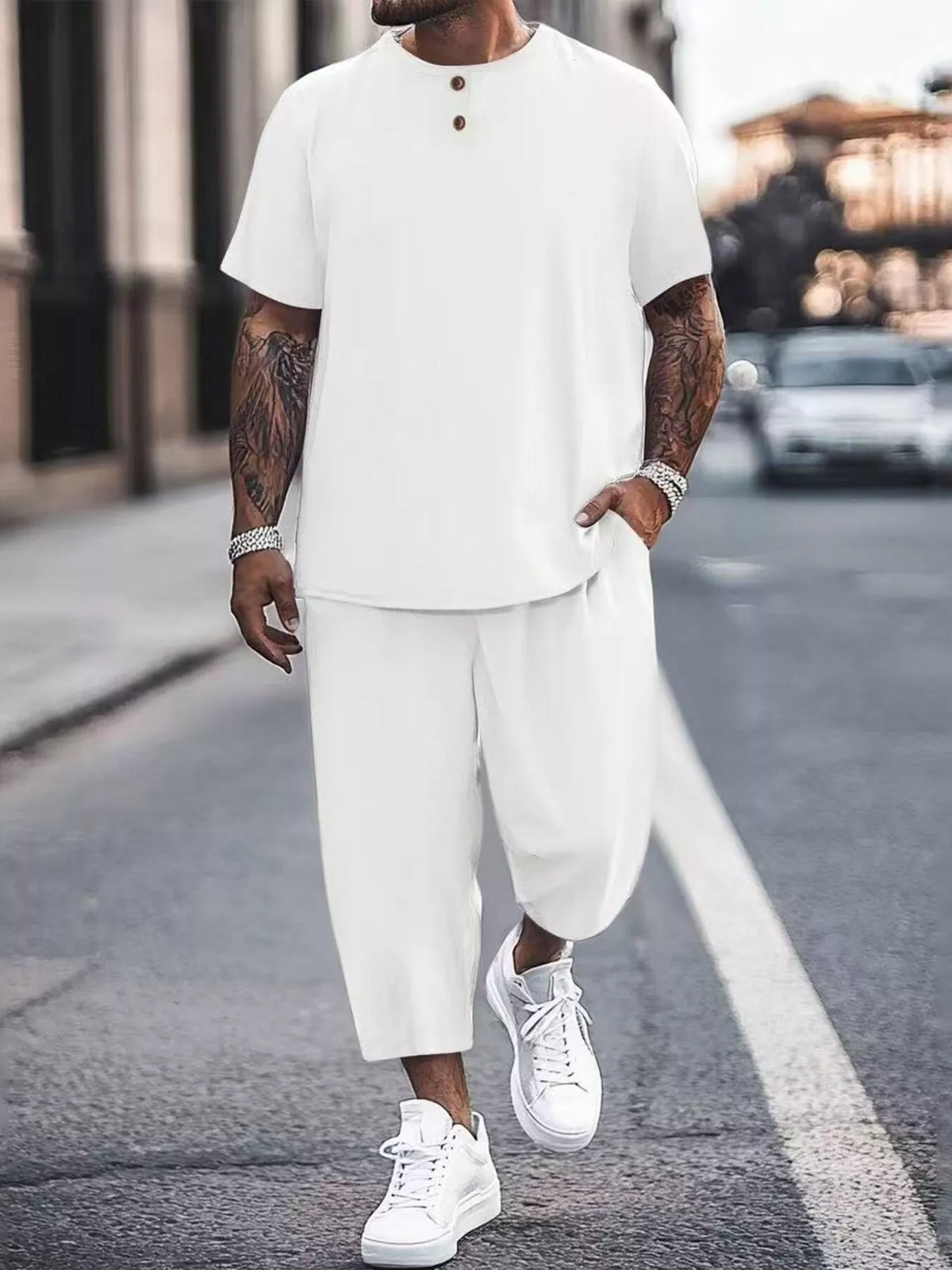 Model wearing white short-sleeve top and cropped pants