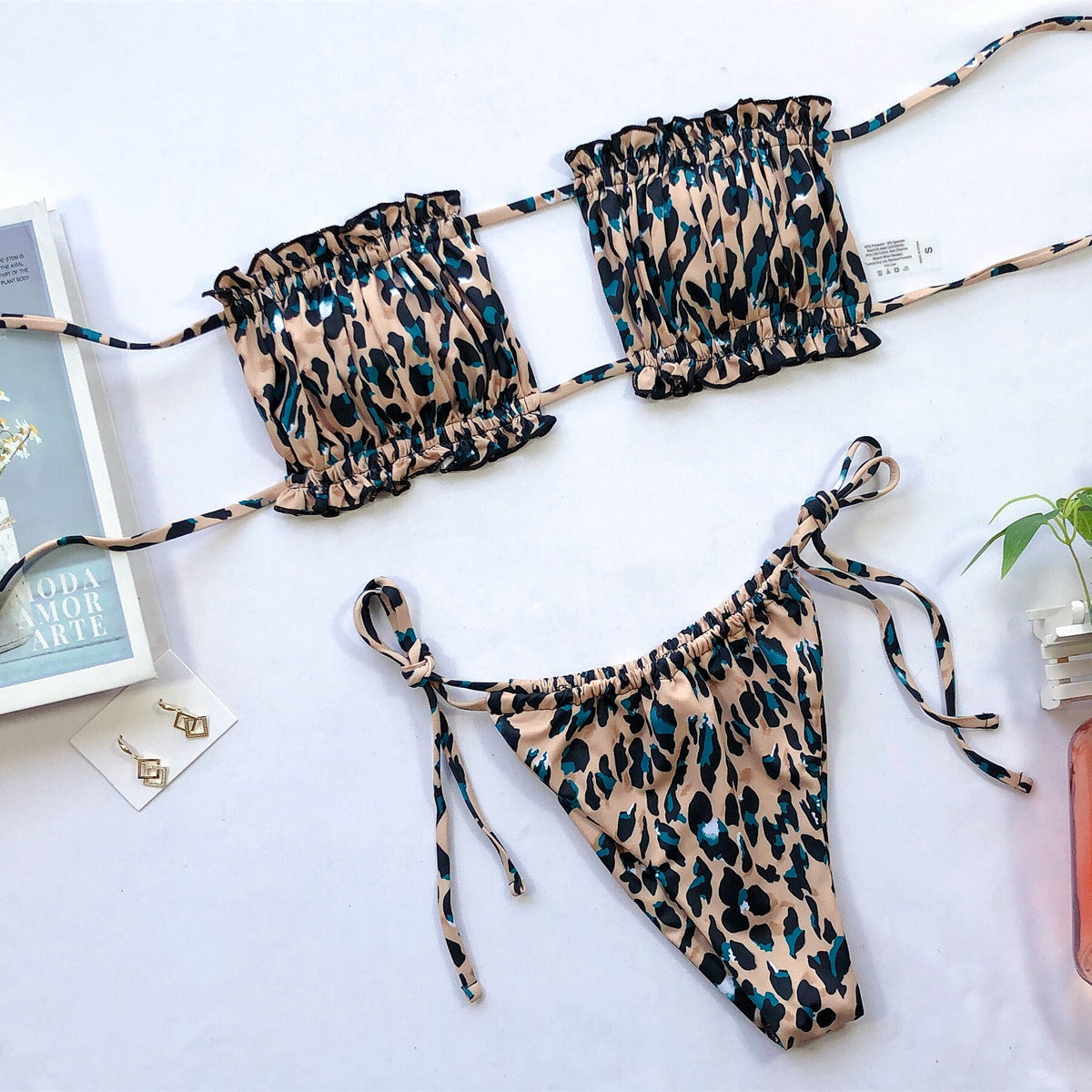 Leopard-print frill bikini top and tie-side briefs laid flat on white