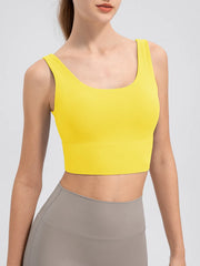 Yellow wide-strap cropped tank with scoop neckline, angled front view