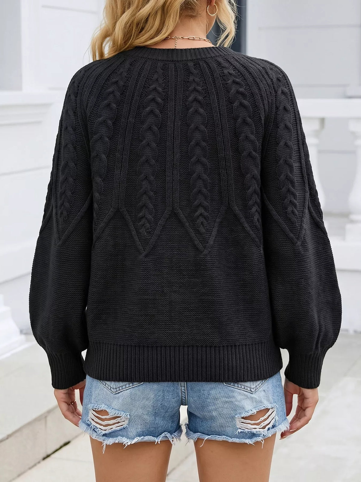 Back view of the black cable-knit sweater