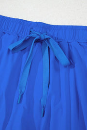 Detail of blue skort waistband with tied drawstring and layered front skirt