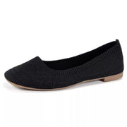 Black mesh slip-on flat shown in profile with low heel