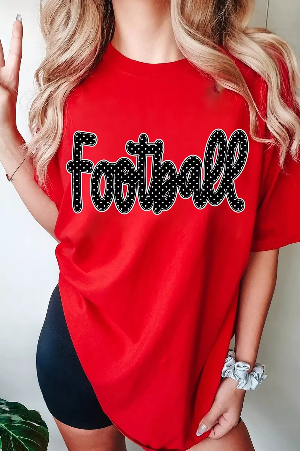 Front view of red football polka-dot lettering graphic T-shirt