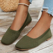 Olive green mesh flats worn with square toes visible