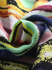 Close-up of the shirt's multicolored striped fabric folded into soft folds