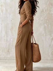 Beige wide-leg jumpsuit modeled from front, showing buttoned waist