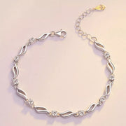 Full view of a silver-tone wavy-link bracelet with floral zircon details and clasp