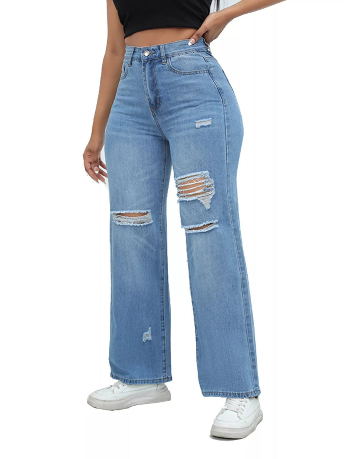 Medium-blue distressed wide-leg jeans on white with one hand in the pocket