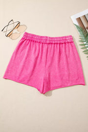 Pink drawstring shorts laid flat, back view