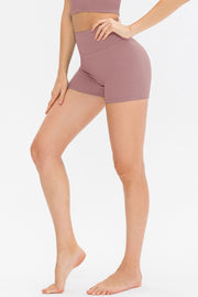 Model wearing dark olive-green ribbed shorts and crop top