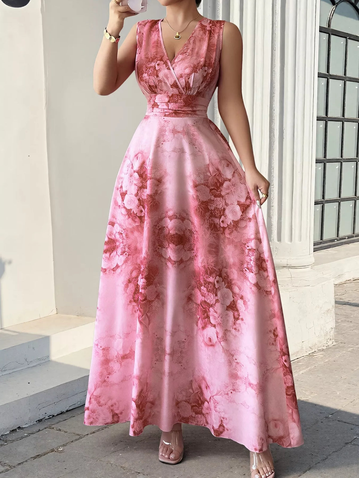 Pink floral sleeveless maxi dress with deep V-neck and defined waist, front view