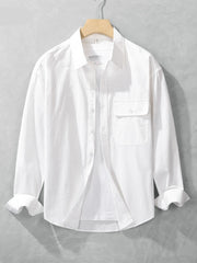 White long-sleeve men's button-up shirt shown from the front with button placket and chest pocket
