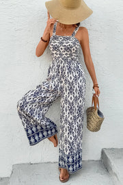 Model wearing printed wide-leg jumpsuit and straw hat