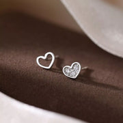 Pair of heart stud earrings with one pavé heart and one open heart
