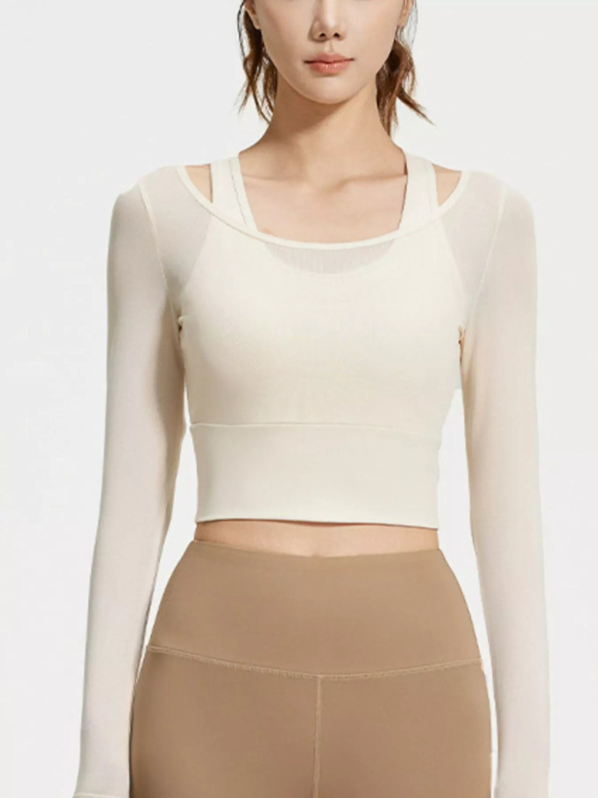Front view of cream long-sleeve cropped active top with inner bra visible beneath the sheer layer