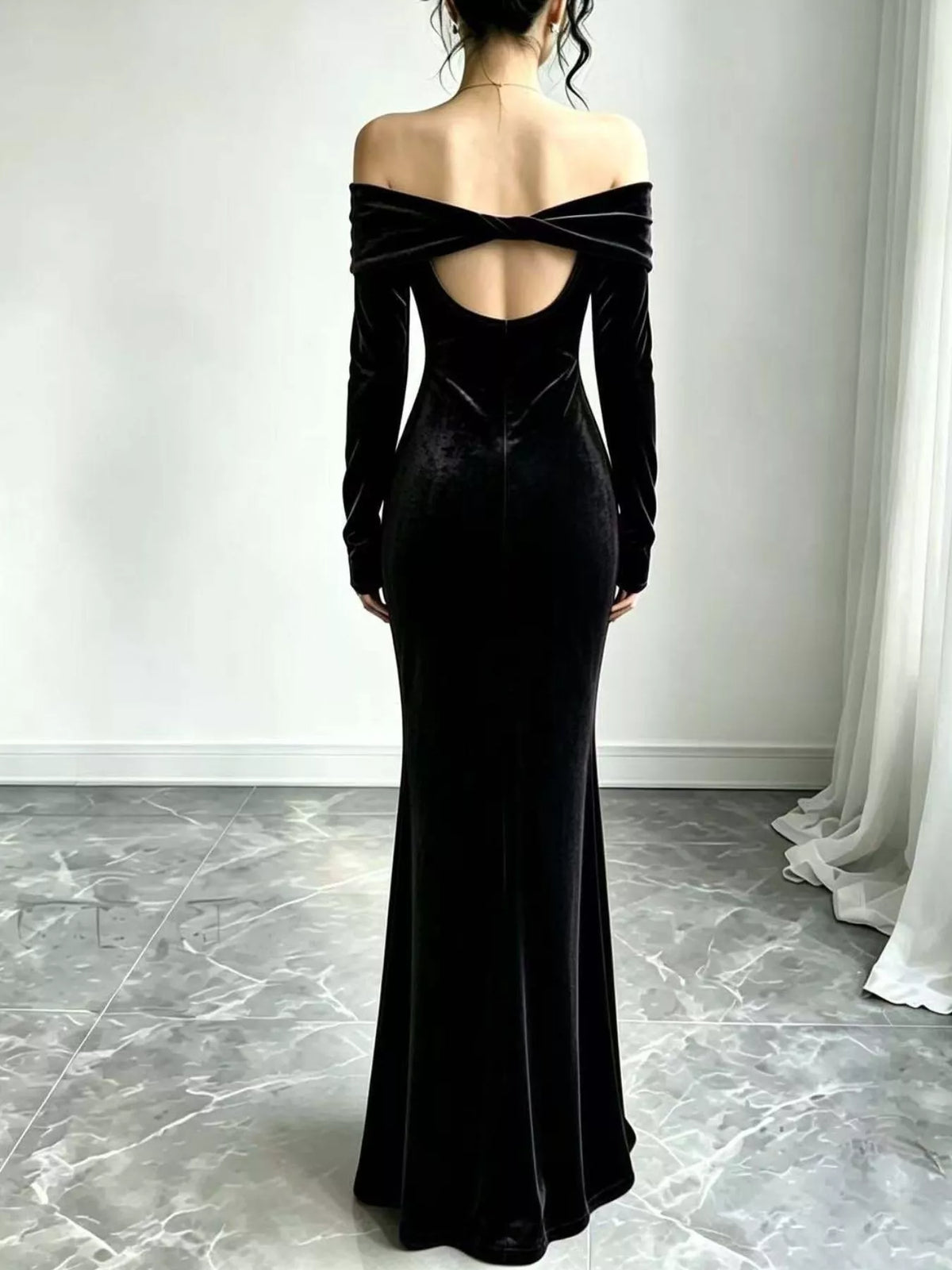 Black velvet maxi dress showing the open back and crossed straps