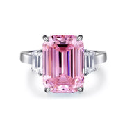 Isolated front view of a rectangular pink gemstone ring with clear baguette side stones