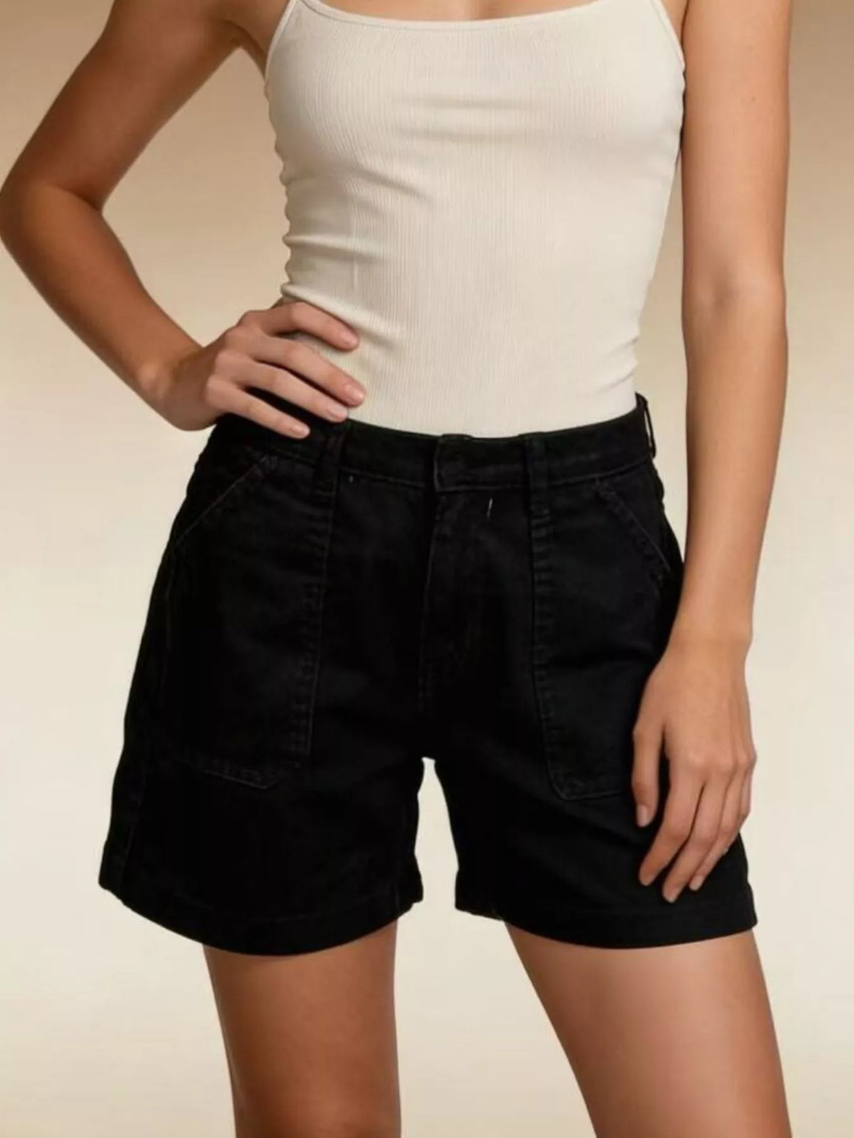 Front view of black pocketed denim shorts with belt loops and wide leg openings