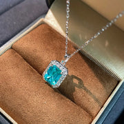 Close angled view of turquoise-blue pendant showing rectangular centre and clear stone border
