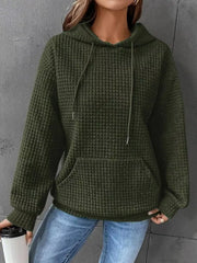 Olive green textured hoodie worn with jeans
